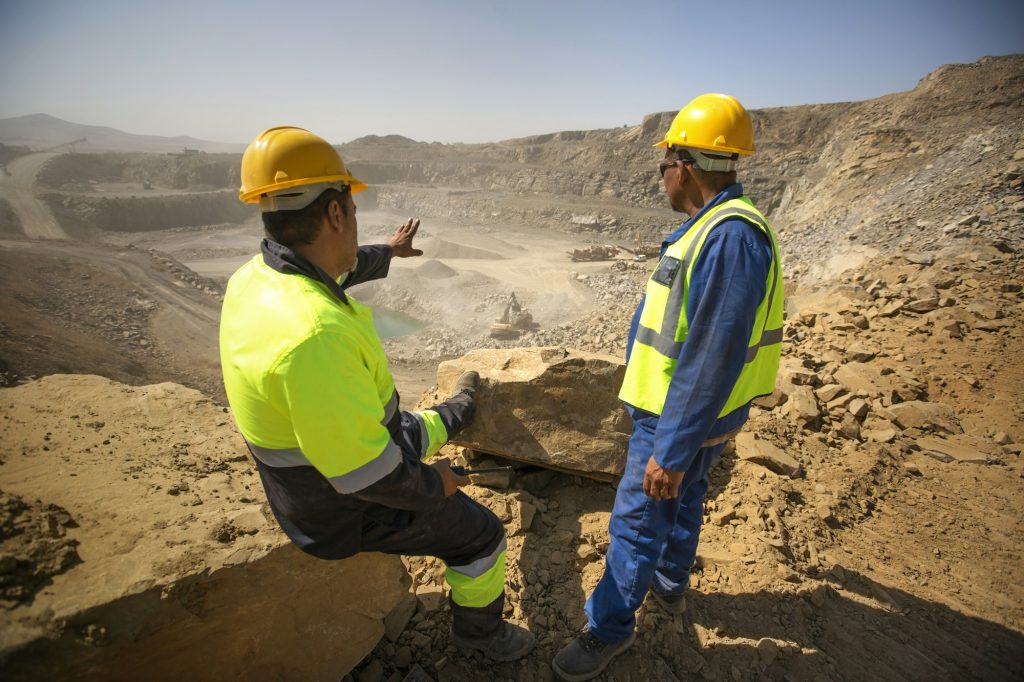 Two quarry workers looking over quarry