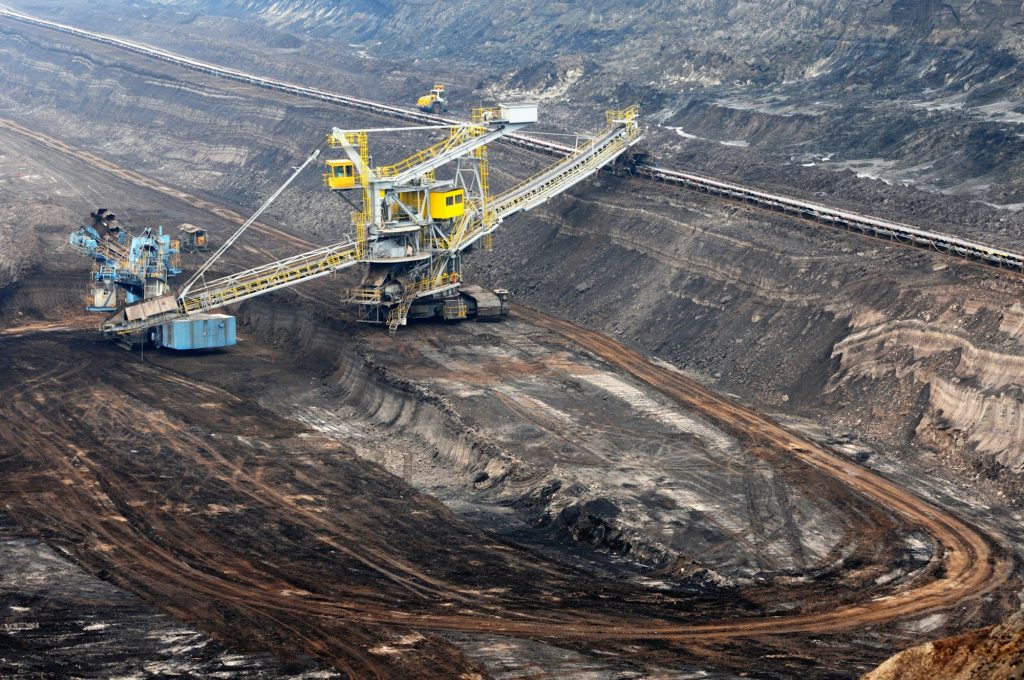 View into a coal mine with working wheel excavator